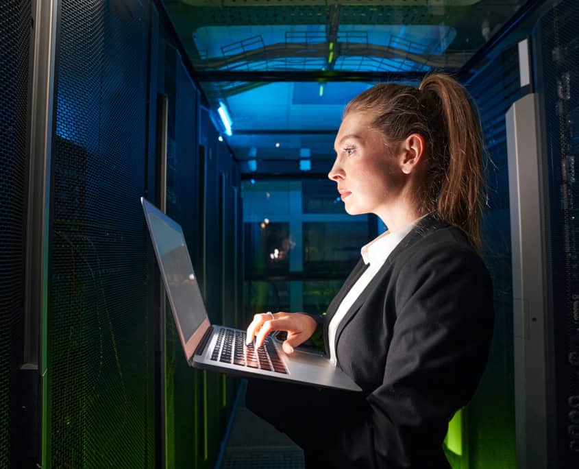 Adult woman network engineer in server room
