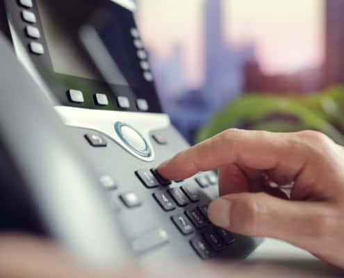 Side view of a VOIP phone being operated