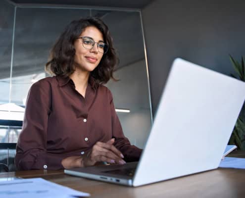 Side view of woman looking at computer