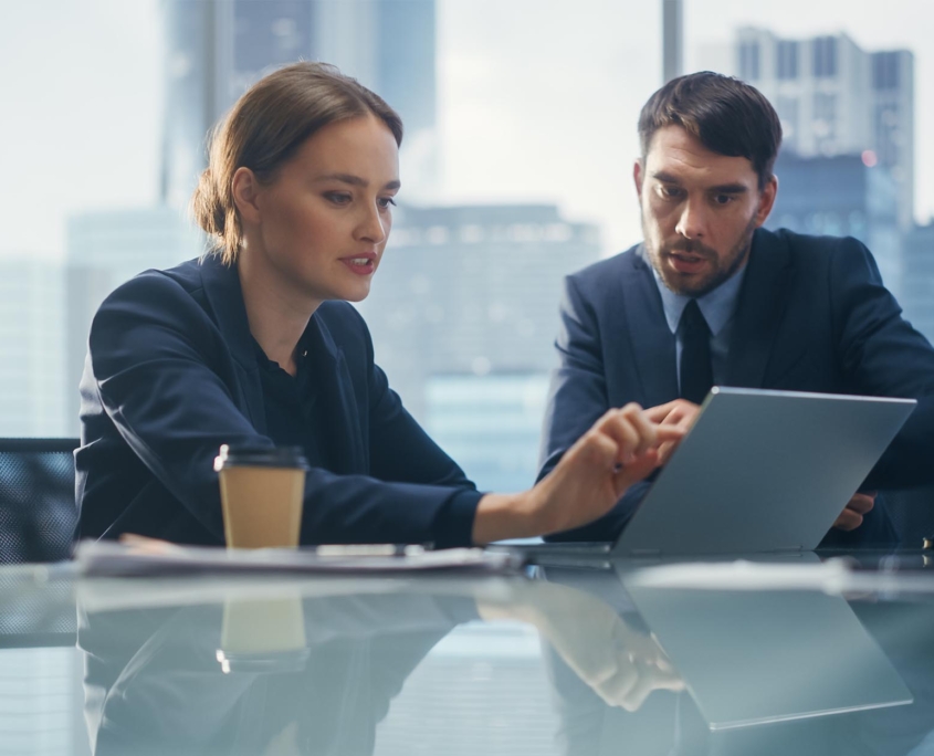 Business people in office looking at laptop