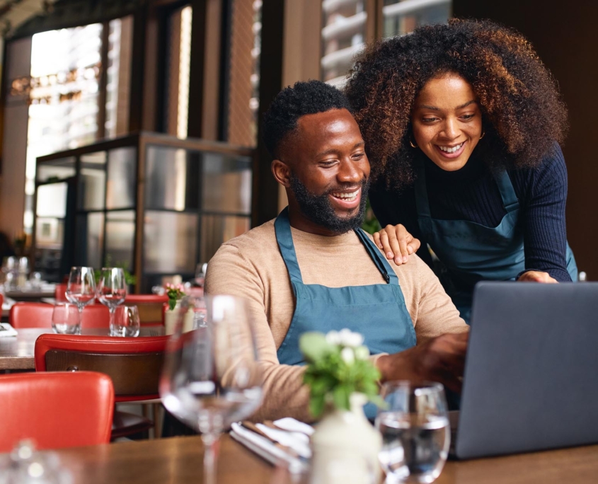 Small business owners looking at laptop